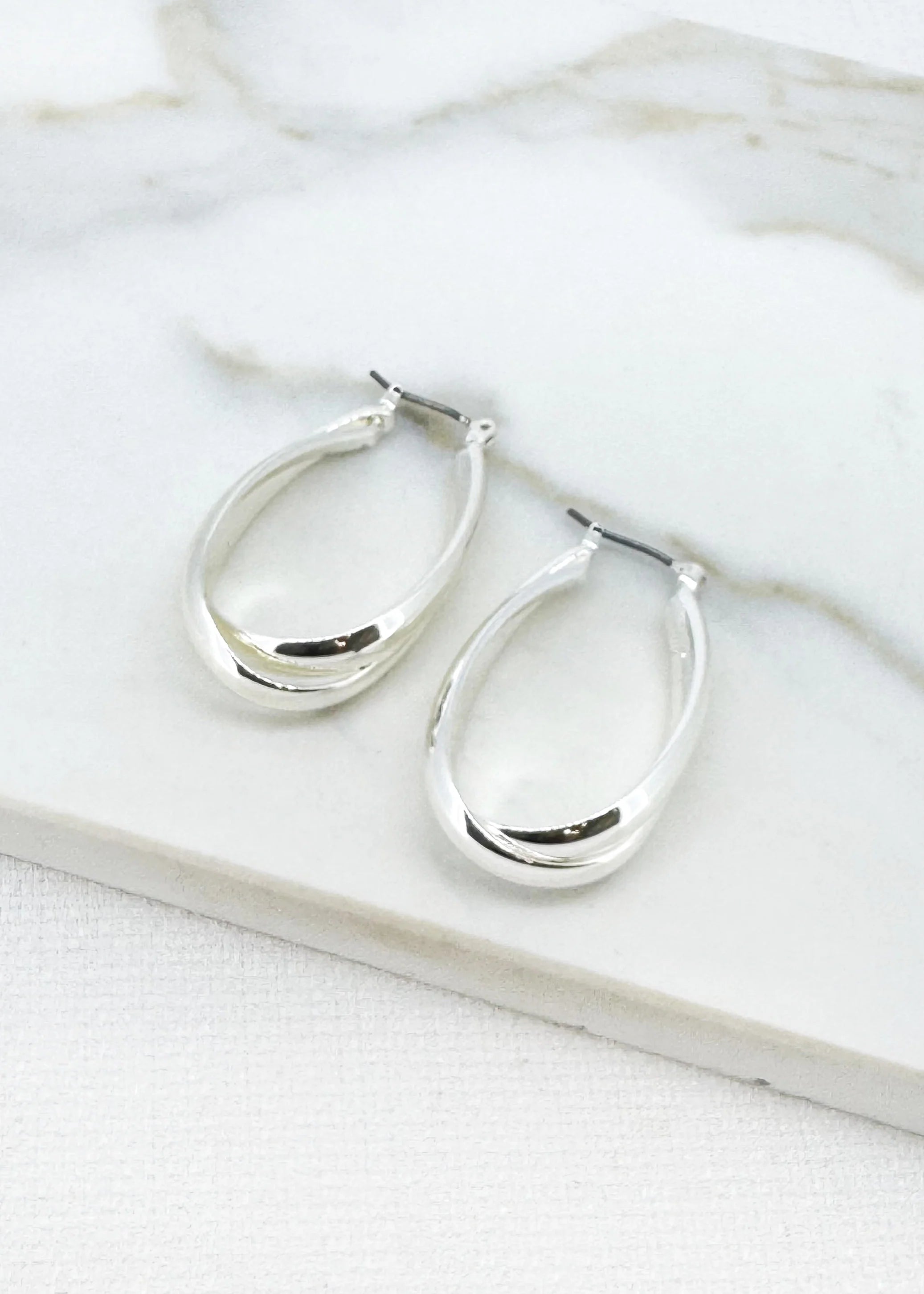 Large silver cross over hoop earring