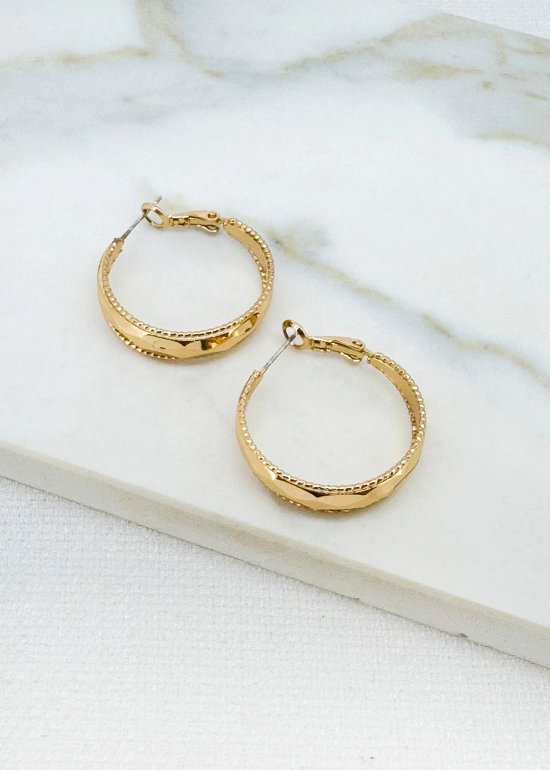 Gold hoop earring with faceted detail