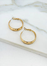 Gold hoop earring with faceted detail