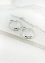 Silver hoop earring with faceted detail