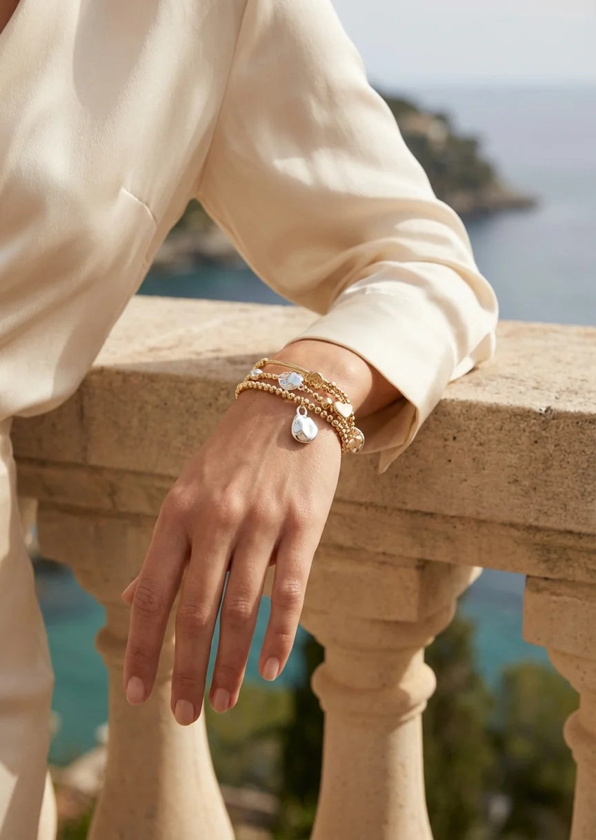 Gold triple layer bracelet with silver bead design