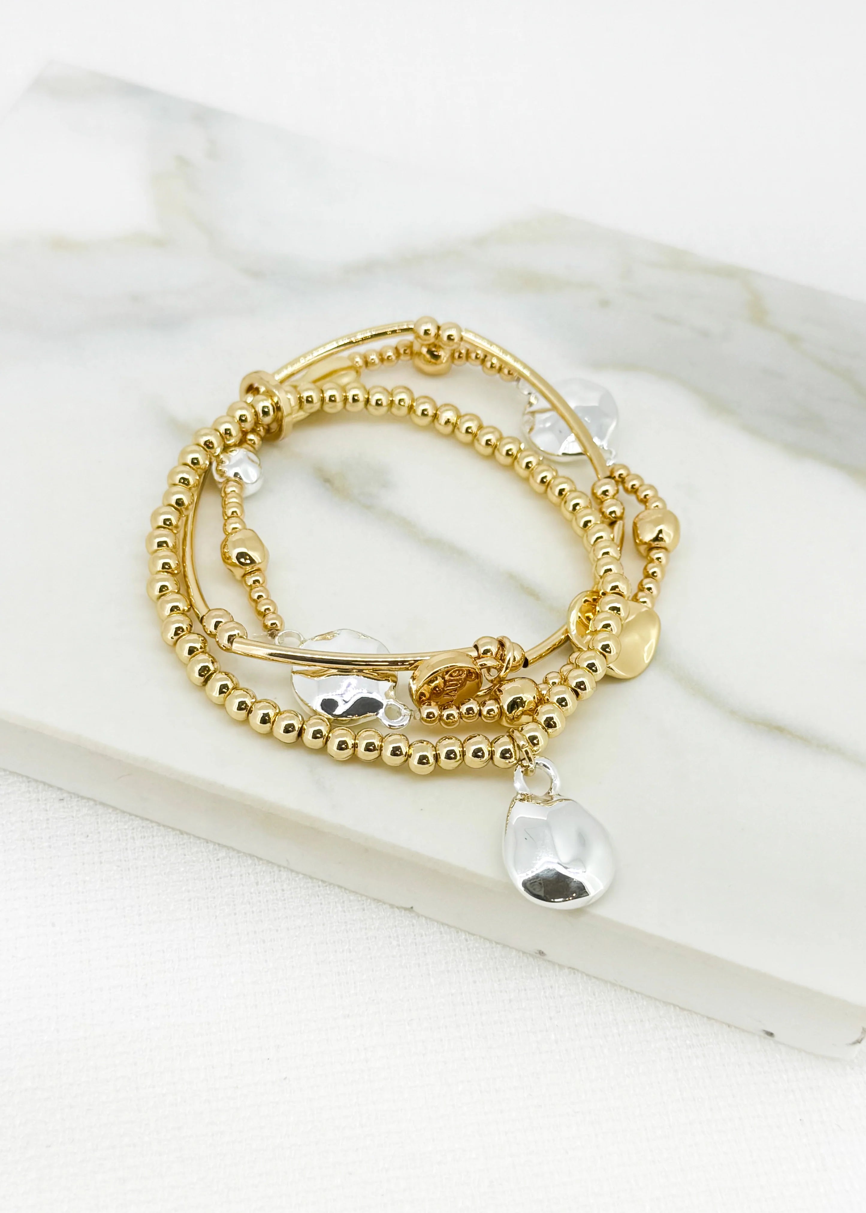 Gold triple layer bracelet with silver bead design