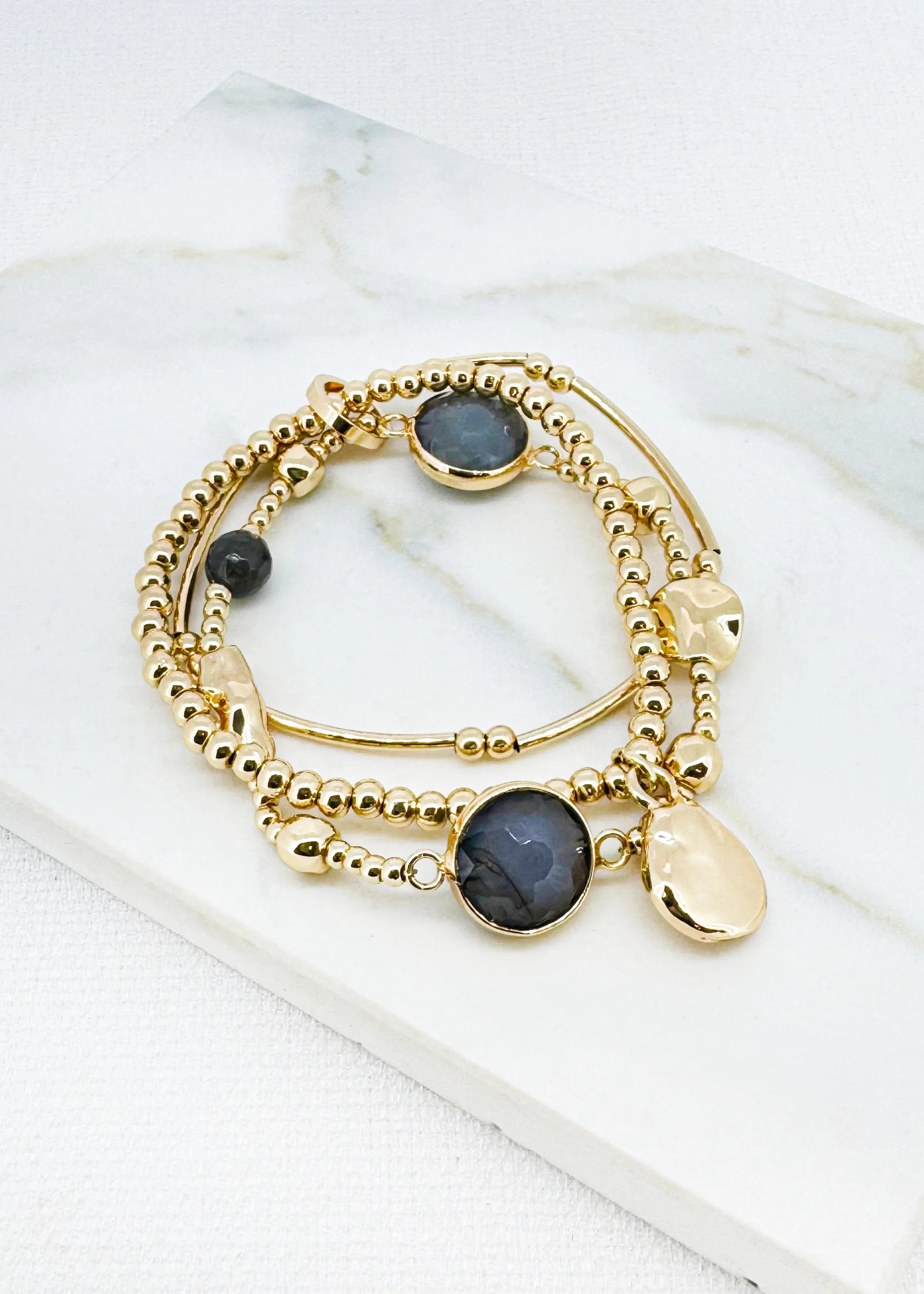 Gold triple layer stretched bracelet with grey bead design